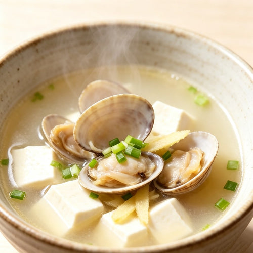 Clam and tofu soup in a light broth with scallion