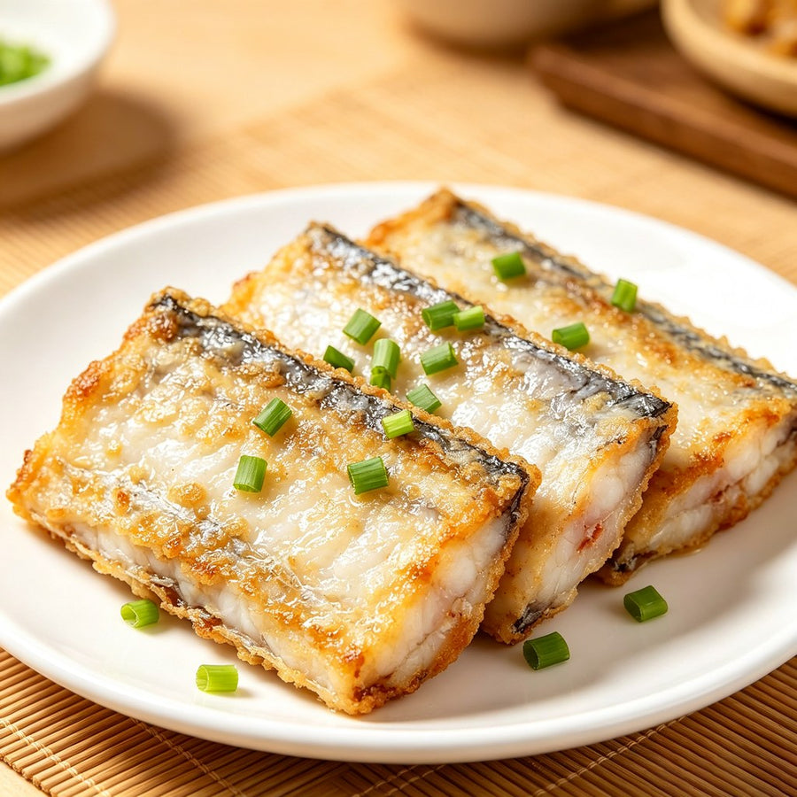 Pan-fried silver beltfish sections topped with spring onion