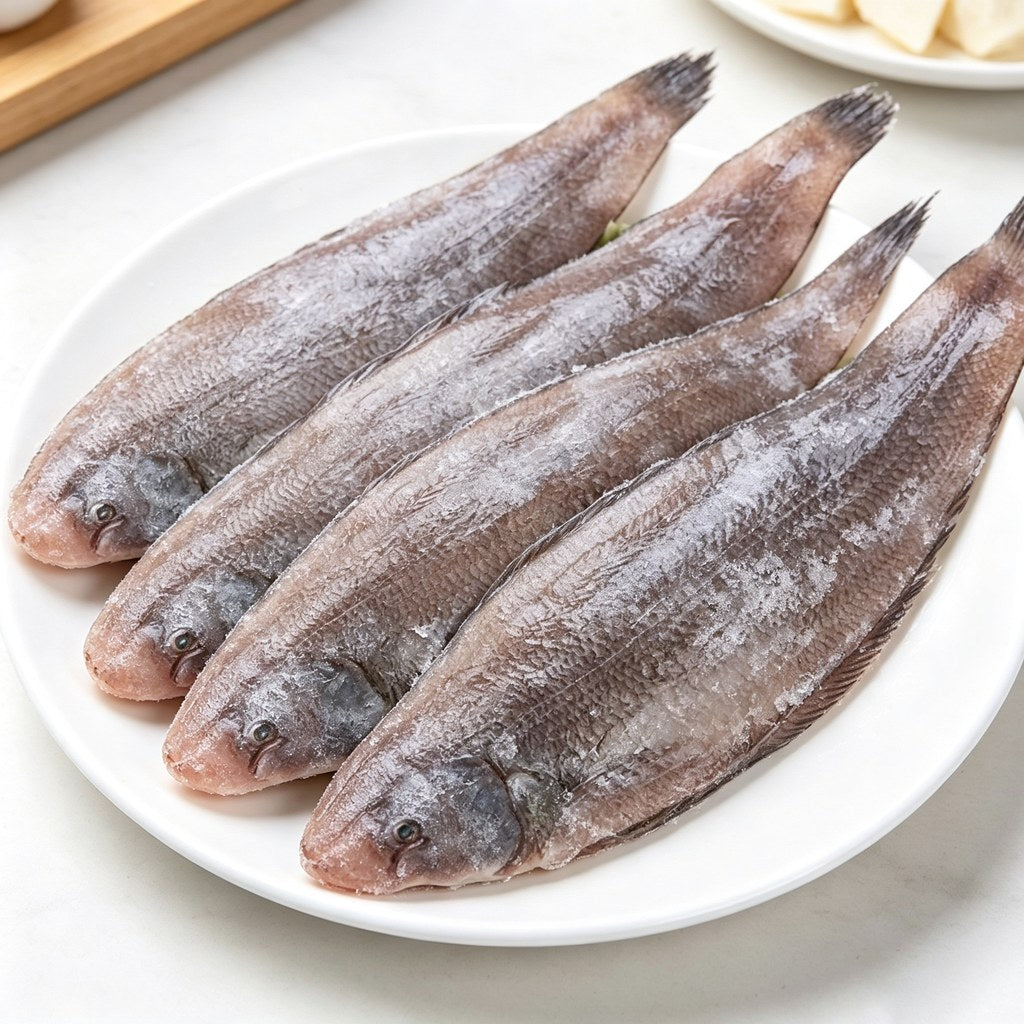 Four whole flatfish laid out on a serving platter